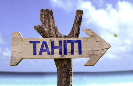 Tahiti wooden sign with a beach on background